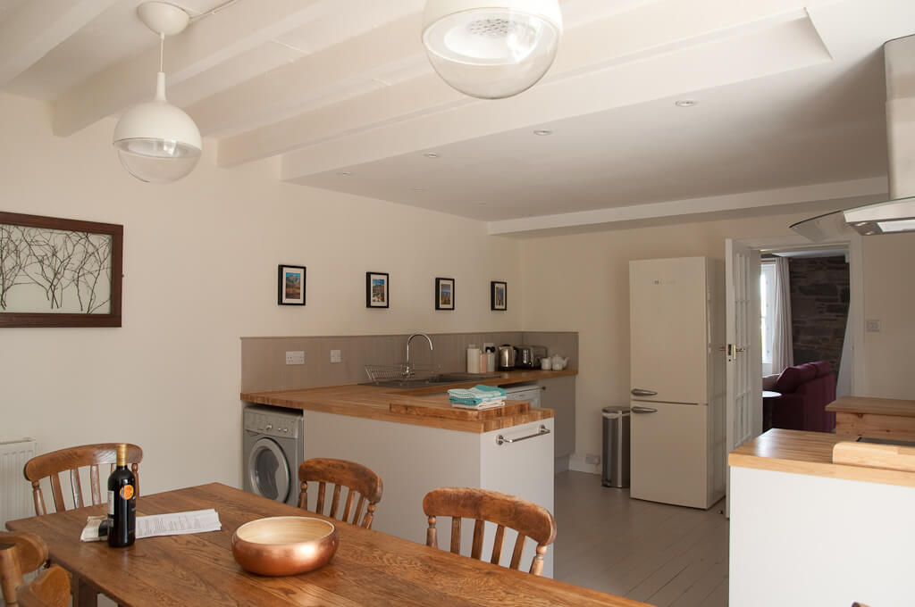 The kitchen contains fan oven, induction hob, dishwasher, microwave, washer dryer and fridge freezer.